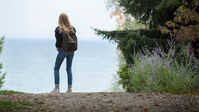 person standing on hiking trail